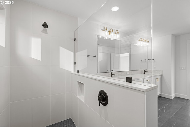 bathroom with vanity and a tile shower