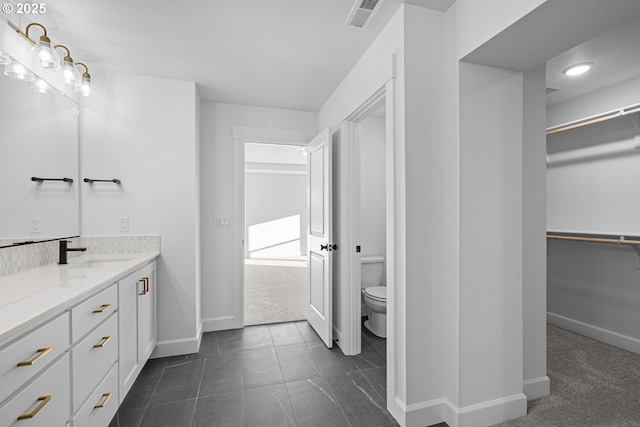 bathroom with vanity and toilet