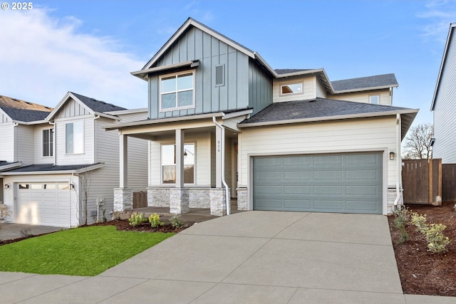 view of front of property featuring a garage, a porch, and a front lawn