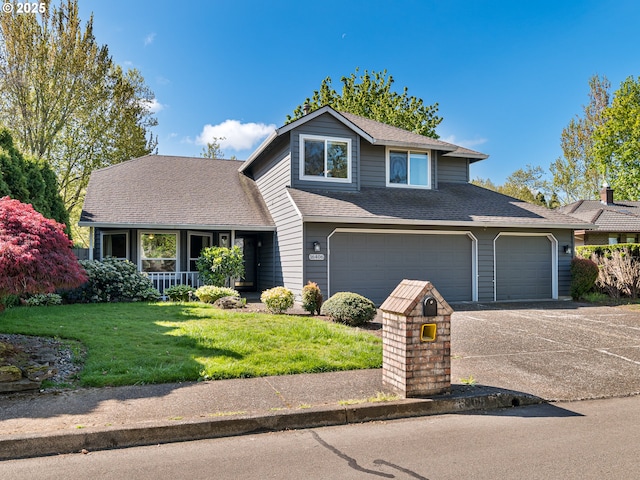 traditional-style house featuring covered porch, driveway, roof with shingles, a front yard, and a garage