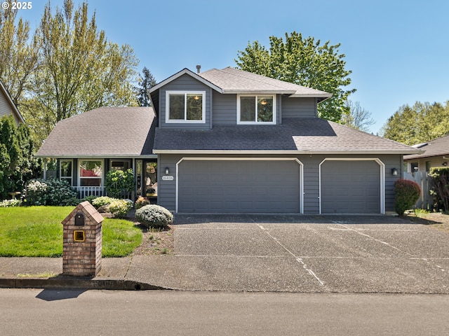 view of front of house with a porch, a front yard, roof with shingles, concrete driveway, and an attached garage