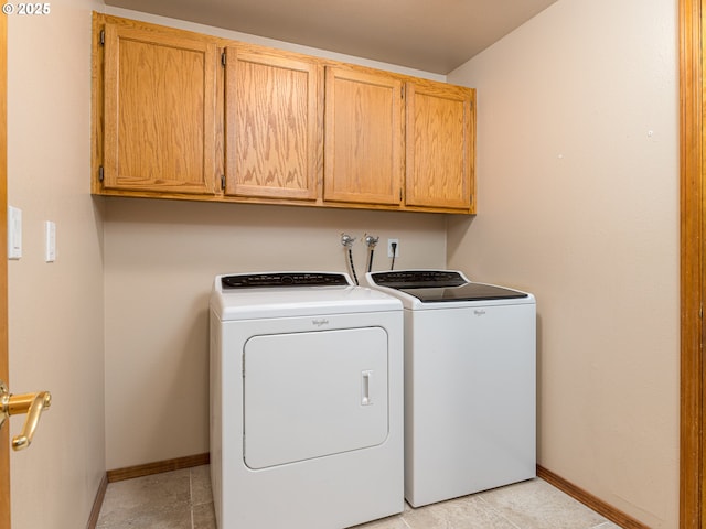 laundry area with cabinet space, separate washer and dryer, baseboards, and light tile patterned floors