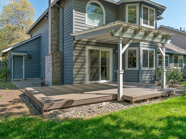 back of property with a pergola and a deck