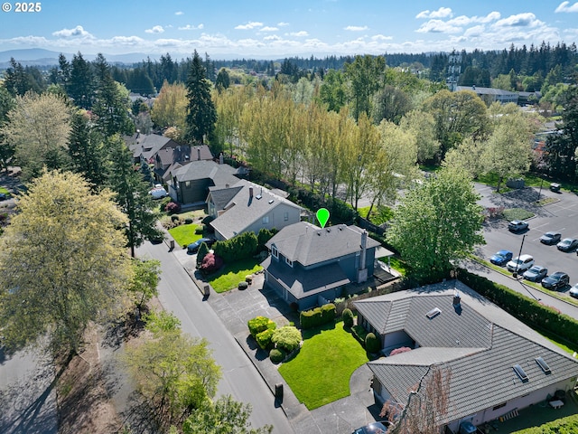 drone / aerial view featuring a residential view and a forest view