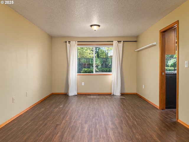 unfurnished room with baseboards, a textured ceiling, and wood finished floors