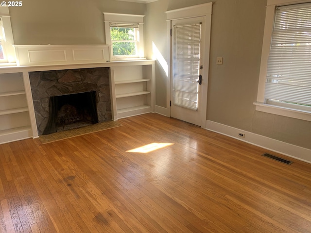 unfurnished living room featuring hardwood / wood-style flooring and a fireplace