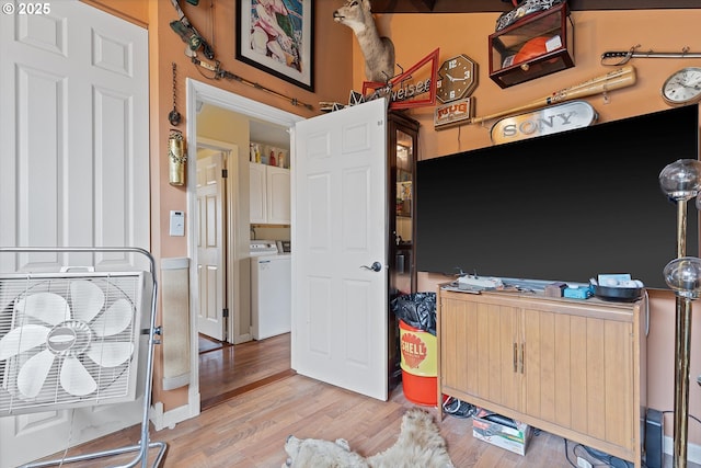 bedroom featuring washing machine and dryer and light wood-type flooring