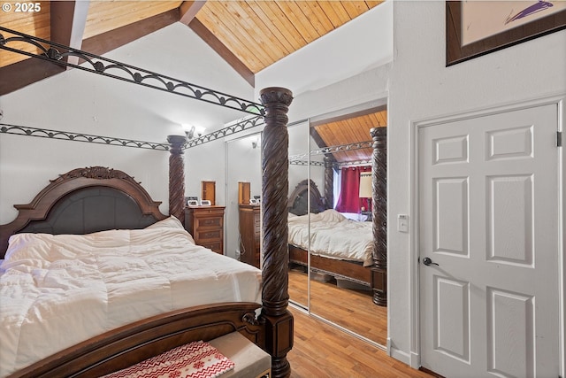 bedroom with lofted ceiling, hardwood / wood-style floors, and wood ceiling