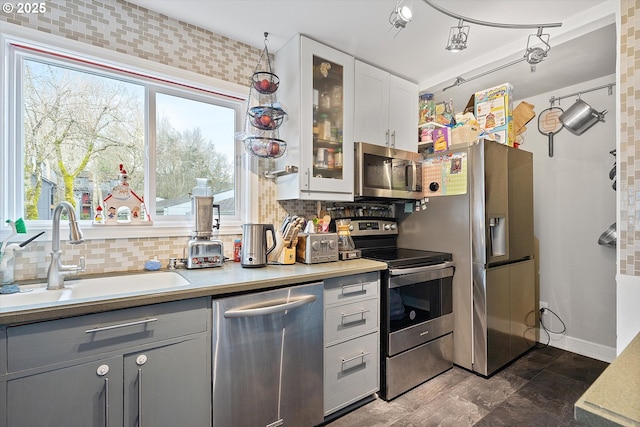 kitchen with sink, gray cabinets, stainless steel appliances, tasteful backsplash, and white cabinets