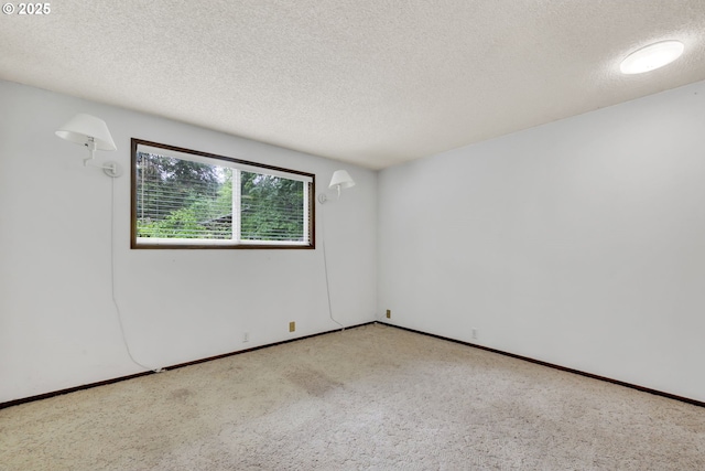 empty room featuring a textured ceiling and carpet floors