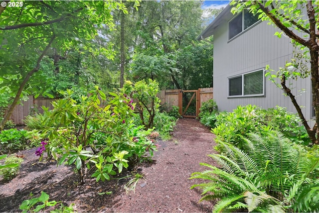view of yard featuring fence and a gate