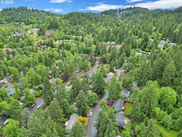 aerial view of property's location with a forest