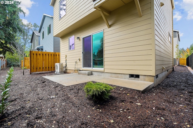 rear view of property featuring a patio and ac unit