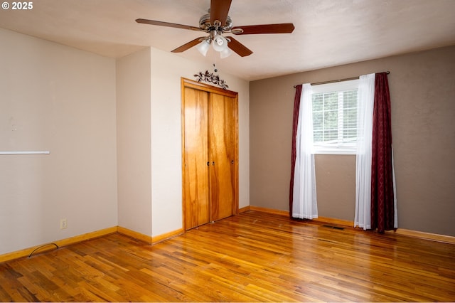 unfurnished bedroom with a closet, baseboards, visible vents, and light wood finished floors