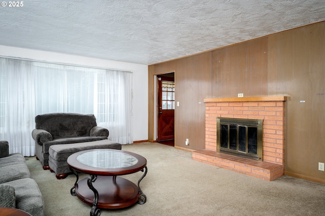 carpeted living area with a textured ceiling, a fireplace, baseboards, and wooden walls