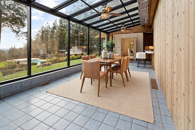 sunroom / solarium with lofted ceiling and a ceiling fan