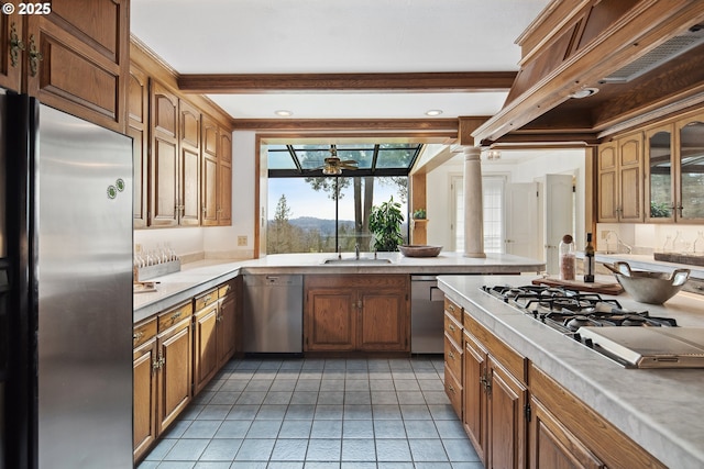 kitchen featuring stainless steel appliances, light countertops, and a sink