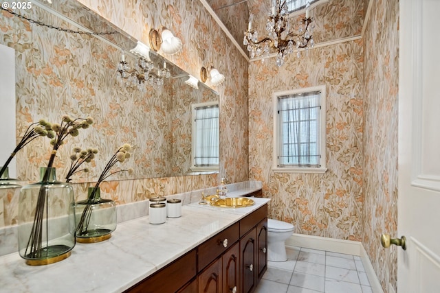 bathroom featuring wallpapered walls, baseboards, toilet, tile patterned floors, and vanity