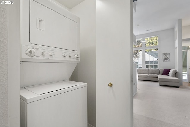 washroom featuring stacked washer and dryer