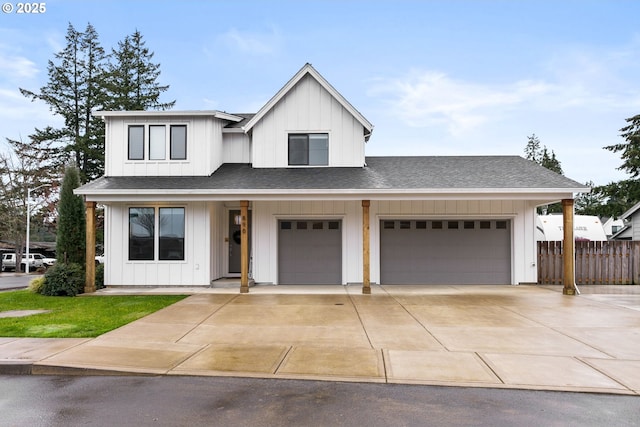 modern farmhouse featuring concrete driveway, a shingled roof, board and batten siding, and fence