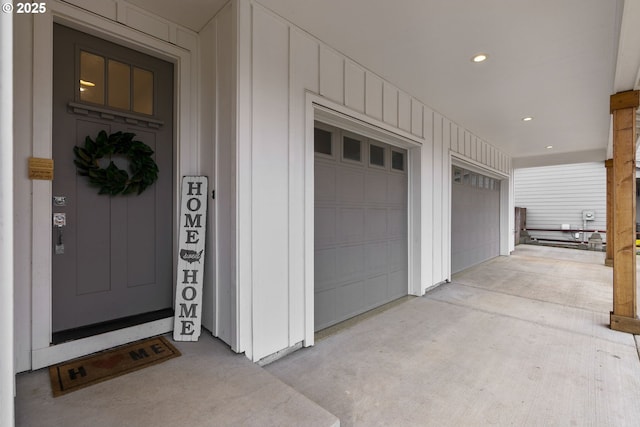 entrance to property featuring board and batten siding and driveway