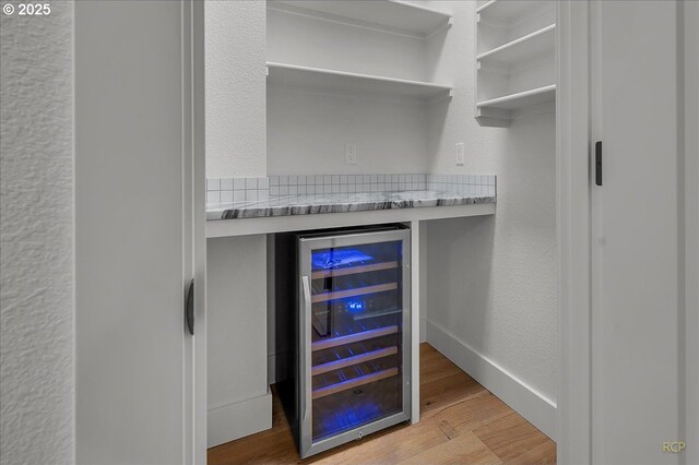 interior space with beverage cooler and hardwood / wood-style flooring