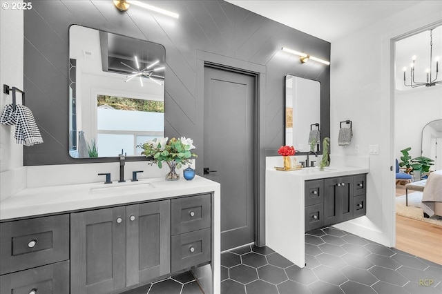 bathroom with tile patterned flooring, a chandelier, and vanity