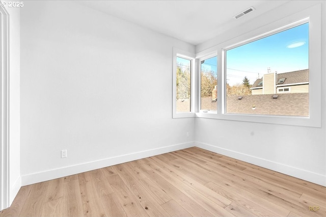 unfurnished room with light hardwood / wood-style flooring