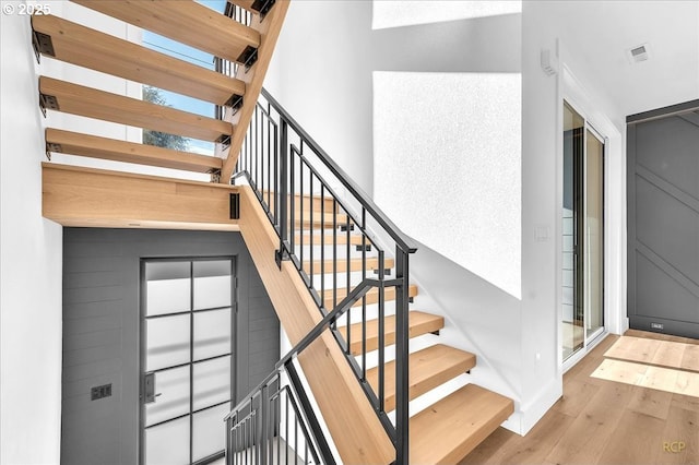 staircase featuring wood-type flooring