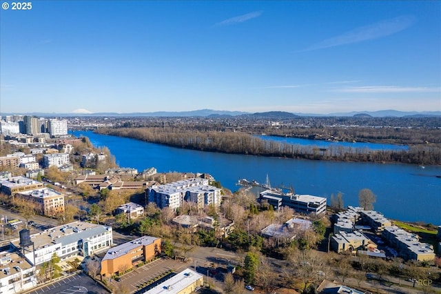 drone / aerial view featuring a water and mountain view