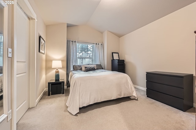 carpeted bedroom with vaulted ceiling