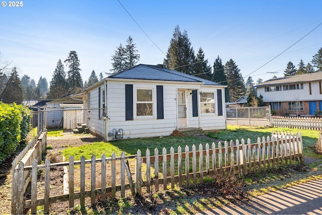 bungalow-style home featuring a front lawn