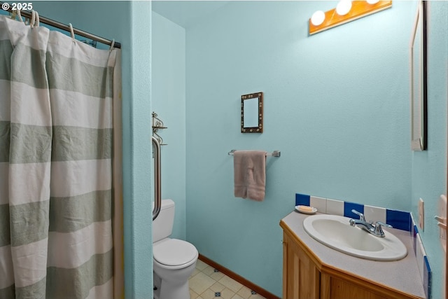 bathroom featuring toilet, vanity, a shower with shower curtain, and baseboards
