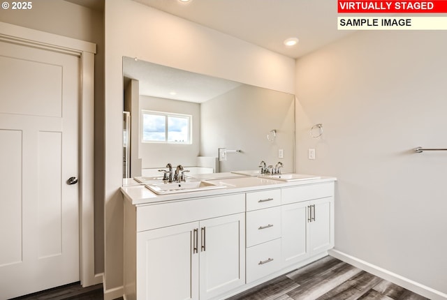 bathroom with hardwood / wood-style flooring and vanity