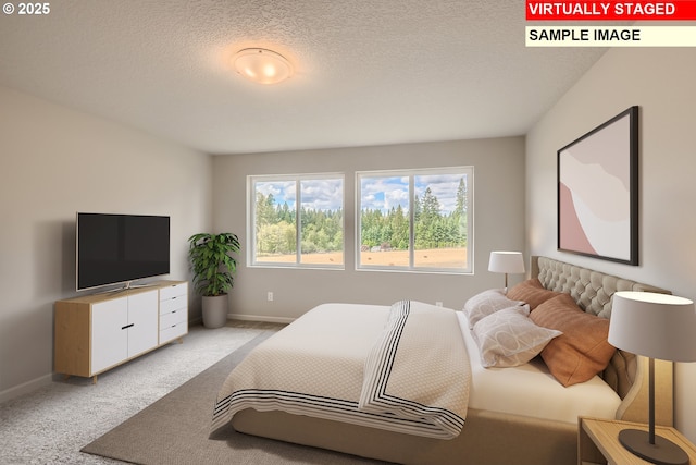 carpeted bedroom featuring a textured ceiling and baseboards