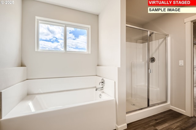 bathroom featuring wood-type flooring and plus walk in shower