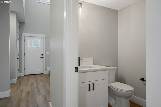 195 Iowa St, Silverton, OR 97381 - half bath featuring vanity, baseboards, toilet, and wood finished floors