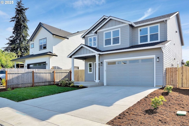 195 Iowa St, Silverton, OR 97381 - view of front facade with fence, board and batten siding, an attached garage, and concrete driveway
