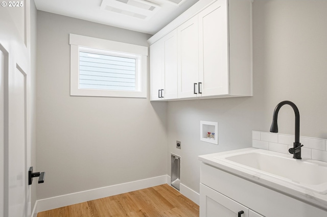 195 Iowa St, Silverton, OR 97381 - washroom with hookup for an electric dryer, cabinet space, a sink, light wood finished floors, and hookup for a washing machine