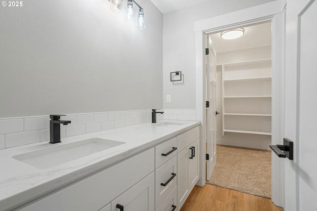 195 Iowa St, Silverton, OR 97381 - bathroom with a sink, decorative backsplash, double vanity, and wood finished floors