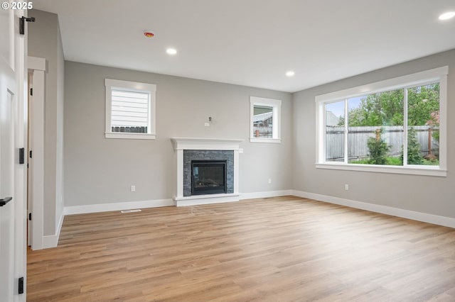 195 Iowa St, Silverton, OR 97381 - unfurnished living room featuring baseboards, a stone fireplace, and light wood-style flooring