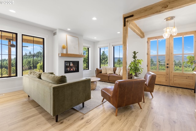 25053 Larson Rd, Monroe, OR 97456 - living area with light wood finished floors, a glass covered fireplace, recessed lighting, and french doors