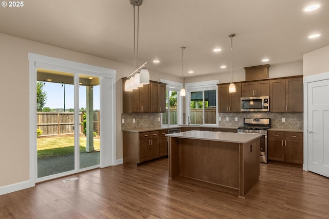 1803 35th Ave, Forest Grove, OR 97116 - kitchen with stainless steel appliances, dark wood-style floors, light countertops, decorative backsplash, and plenty of natural light