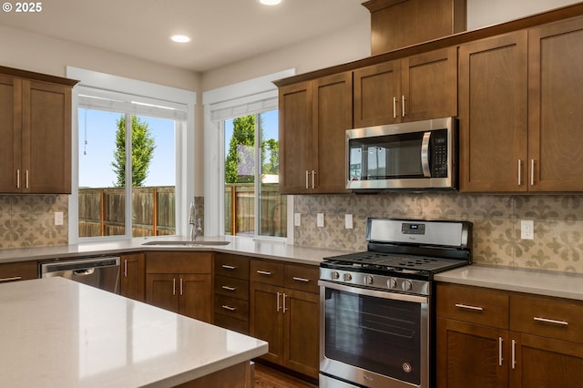 1803 35th Ave, Forest Grove, OR 97116 - kitchen with appliances with stainless steel finishes, light countertops, a sink, recessed lighting, and backsplash