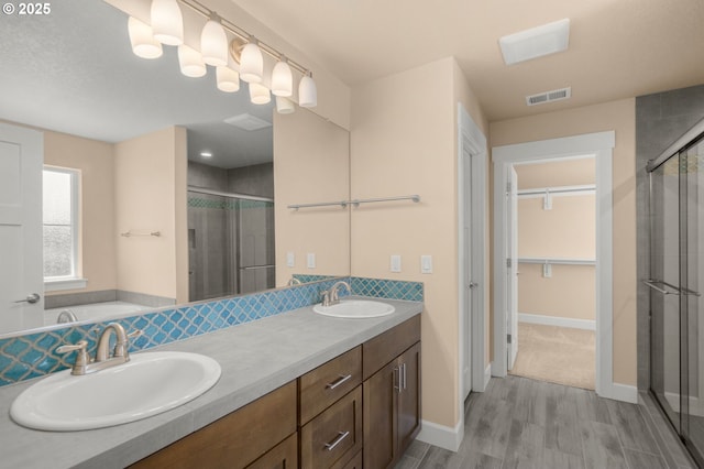 1803 35th Ave, Forest Grove, OR 97116 - bathroom featuring a shower stall, wood finished floors, a spacious closet, and double vanity