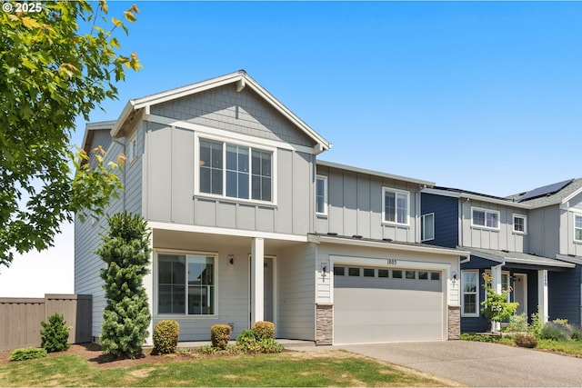 1803 35th Ave, Forest Grove, OR 97116 - view of front of house with board and batten siding, an attached garage, asphalt driveway, and stone siding