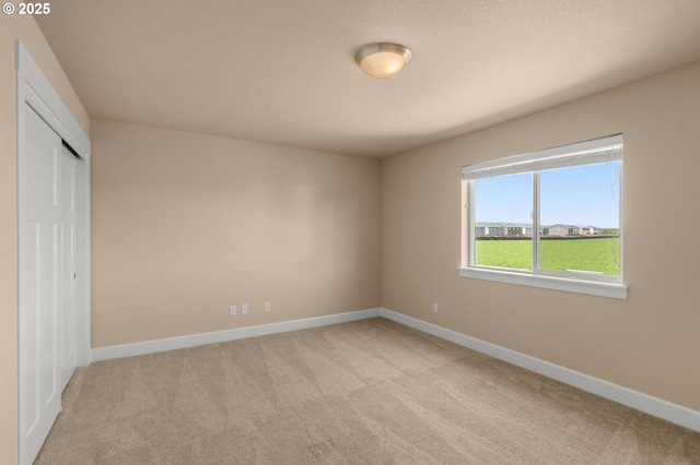 1803 35th Ave, Forest Grove, OR 97116 - unfurnished bedroom with light carpet, baseboards, and a closet