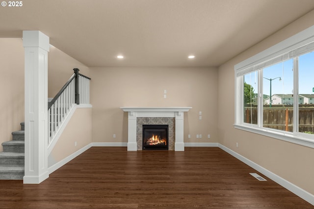 1803 35th Ave, Forest Grove, OR 97116 - unfurnished living room with dark wood-style flooring, stairs, a tiled fireplace, recessed lighting, and baseboards