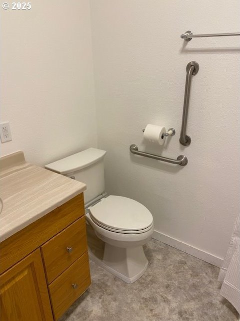 82277 Davisson Rd, Creswell, OR 97426 - bathroom with toilet, vanity, and baseboards