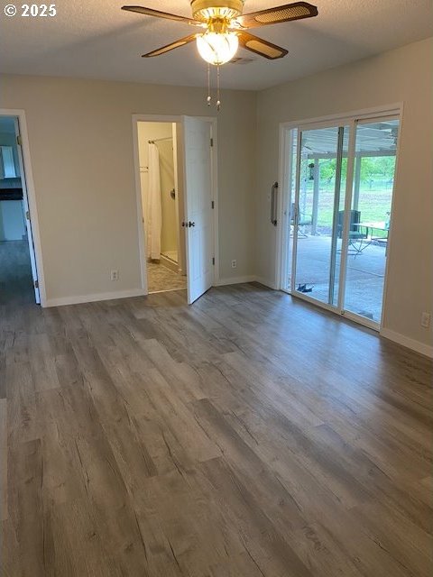 82277 Davisson Rd, Creswell, OR 97426 - spare room featuring baseboards, wood finished floors, and a ceiling fan